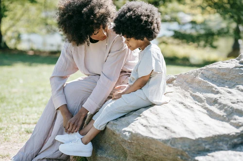 Mother and young child interacting outdoors