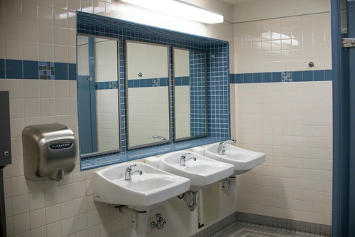 Clean public restroom with three sinks